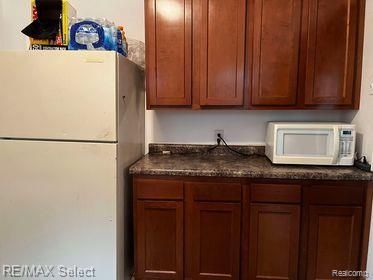 kitchen with dark stone countertops and white appliances