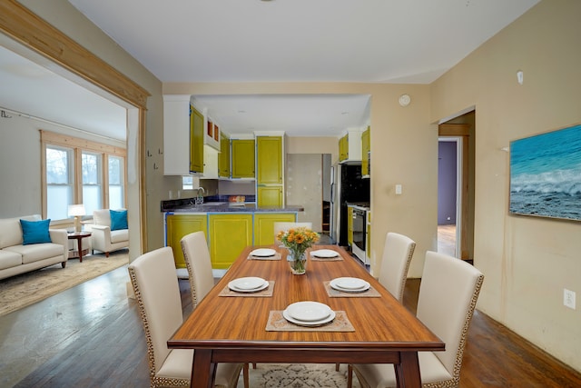 dining space featuring sink and hardwood / wood-style flooring