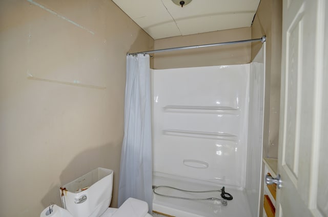 bathroom featuring toilet and walk in shower