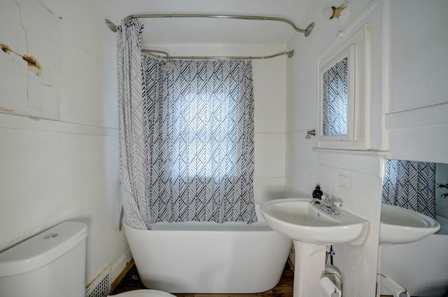 full bathroom with sink, shower / tub combo, and toilet