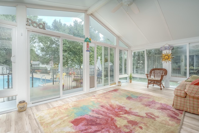 sunroom with lofted ceiling with beams and ceiling fan