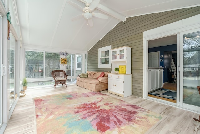 sunroom with vaulted ceiling with beams and ceiling fan