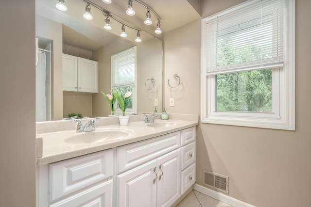 bathroom with vanity, tile patterned flooring, and plenty of natural light