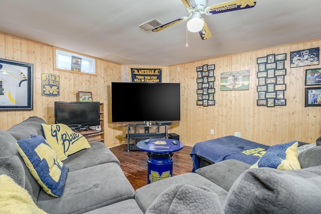 living room featuring ceiling fan and dark hardwood / wood-style flooring