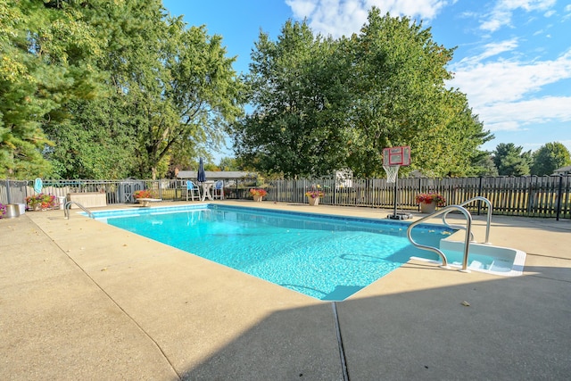 view of swimming pool with a patio