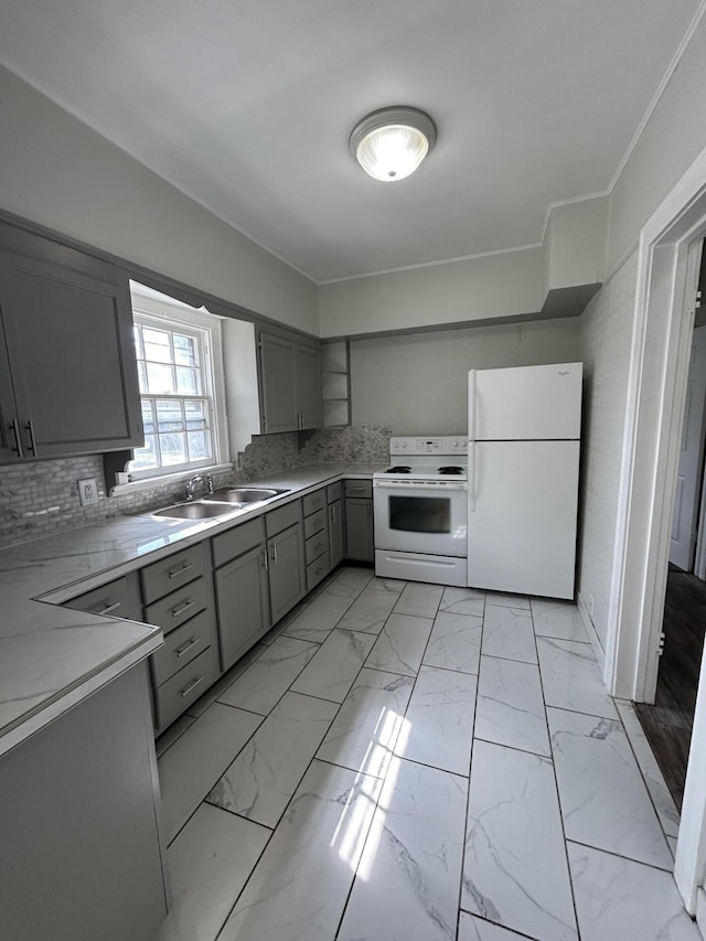 kitchen with sink, gray cabinetry, backsplash, and white appliances