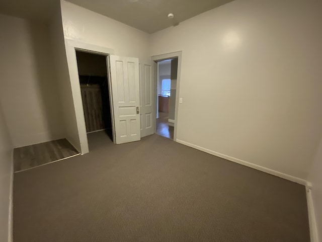 unfurnished bedroom featuring carpet floors and a closet