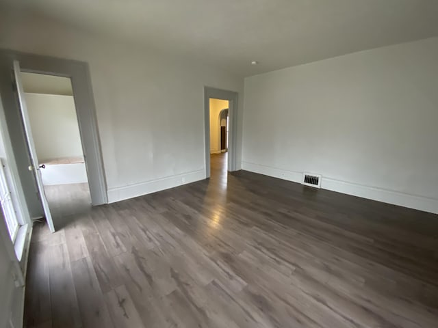 empty room featuring dark hardwood / wood-style flooring