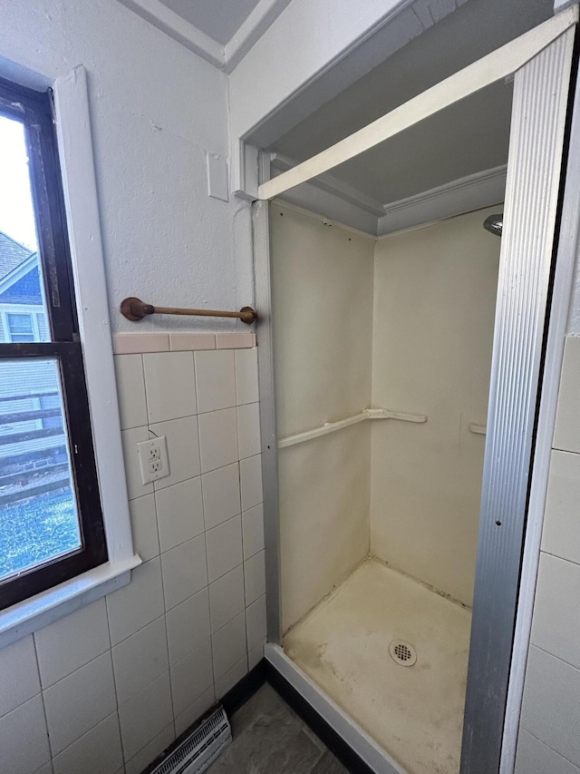 bathroom with tile walls