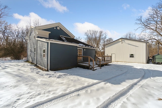 snow covered house featuring a deck