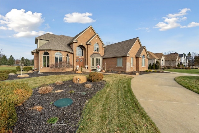 view of front of property featuring a front yard and french doors