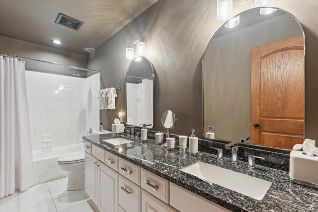 bathroom featuring tile patterned flooring, visible vents, toilet, and a sink