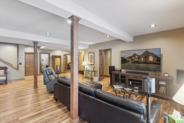 living area featuring ornate columns, beam ceiling, recessed lighting, stairs, and light wood-type flooring