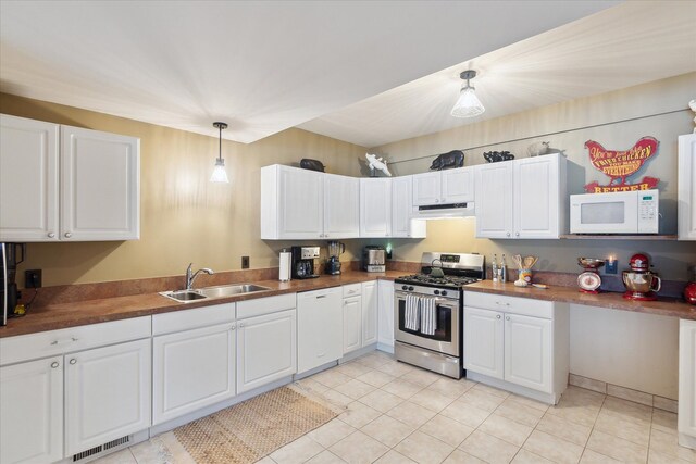 kitchen with white appliances, visible vents, a sink, white cabinets, and under cabinet range hood