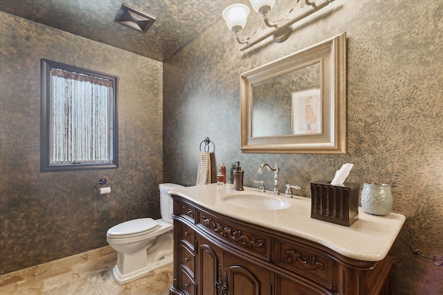 half bath with toilet, vanity, and an inviting chandelier