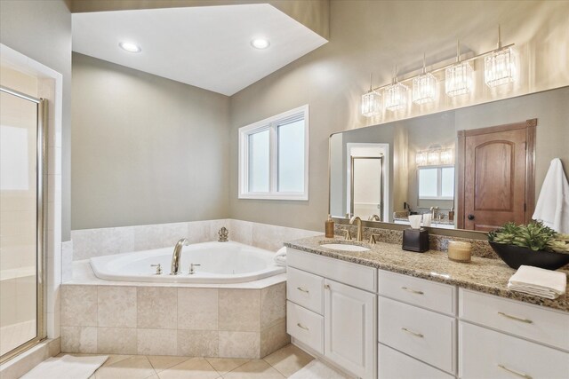 full bathroom with tile patterned flooring, a garden tub, a stall shower, and a wealth of natural light