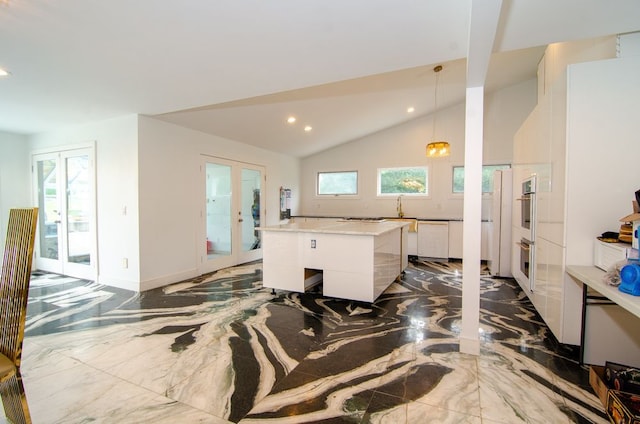 kitchen featuring white cabinetry, decorative light fixtures, french doors, and a center island