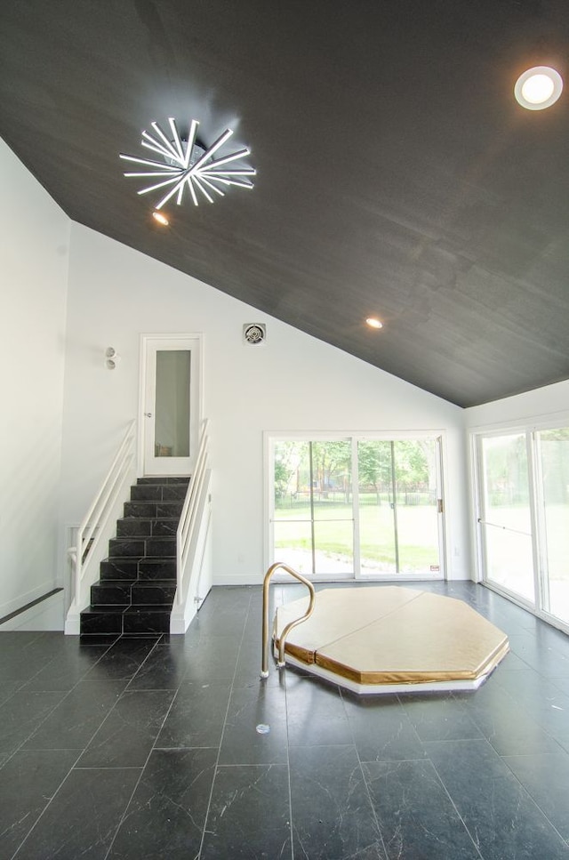 interior space with vaulted ceiling and a baseboard heating unit