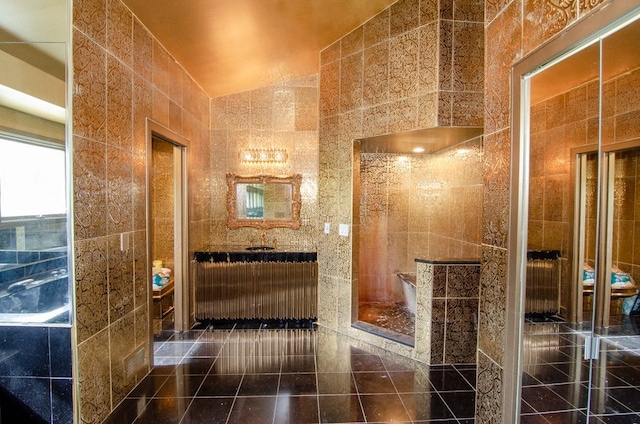 bathroom with tile patterned floors, lofted ceiling, and tile walls