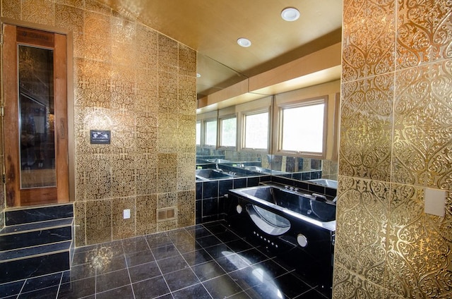 bathroom featuring a tub, tile walls, and tile patterned floors