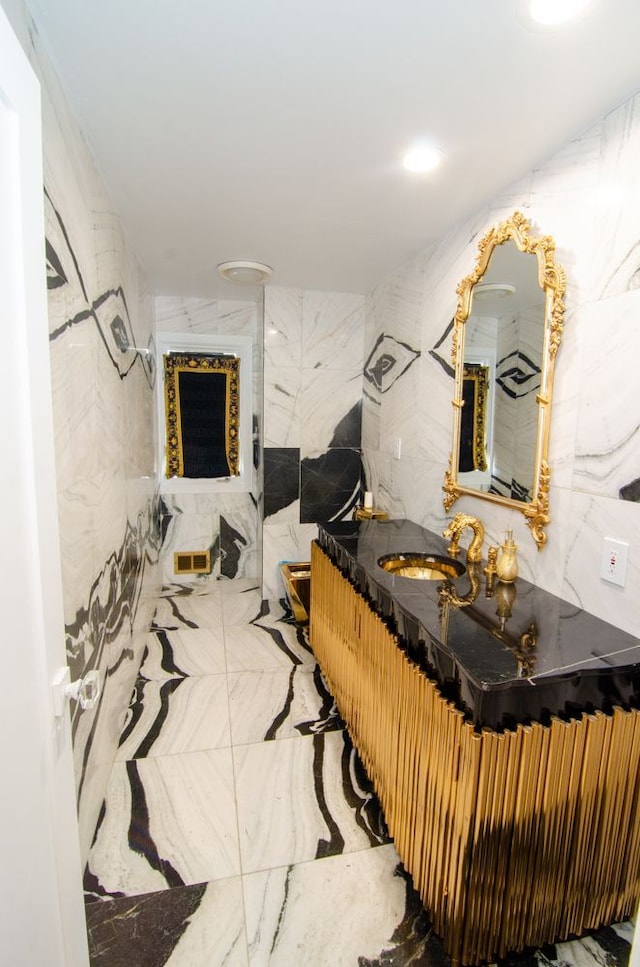 bathroom with tile walls and vanity