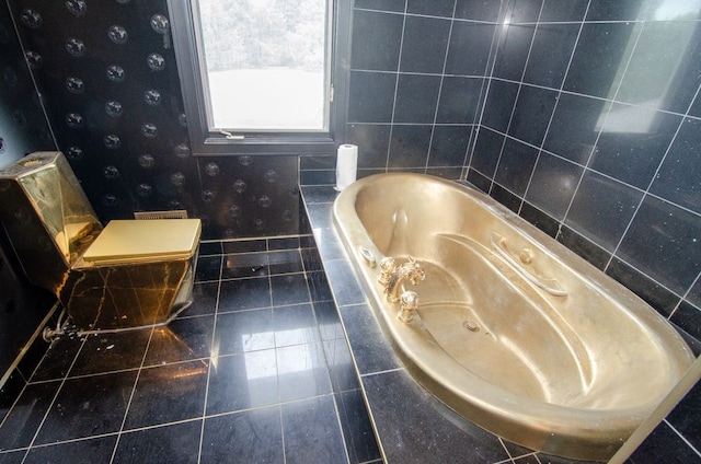 bathroom featuring tiled tub and tile patterned flooring