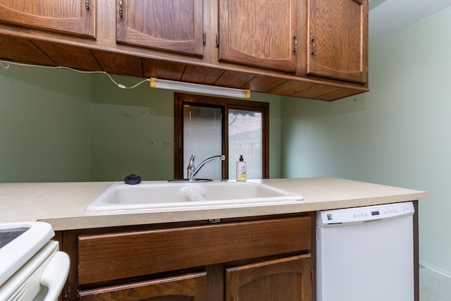 kitchen featuring sink, dishwasher, and range