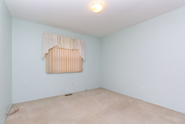 empty room featuring light carpet