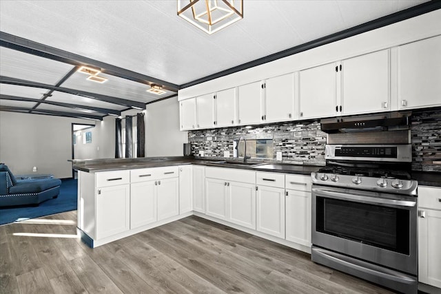 kitchen with sink, stainless steel gas stove, white cabinetry, light hardwood / wood-style floors, and backsplash