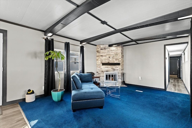 sitting room featuring beam ceiling, ornamental molding, and a fireplace