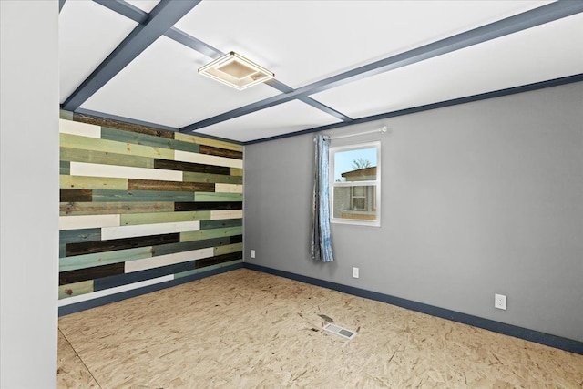 unfurnished room featuring wooden walls