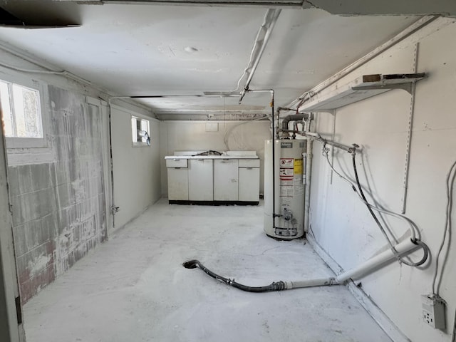 basement featuring a wealth of natural light and gas water heater