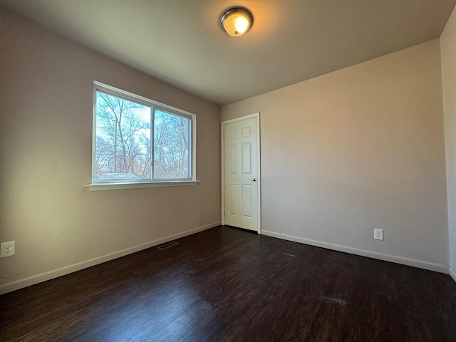 spare room featuring dark hardwood / wood-style floors