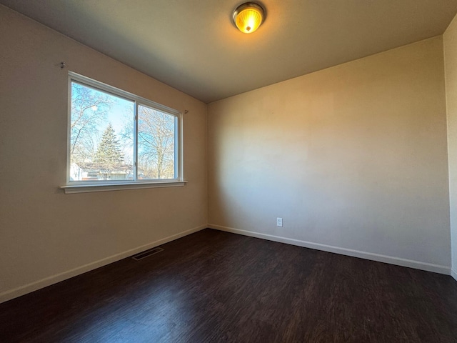 unfurnished room featuring dark wood-type flooring