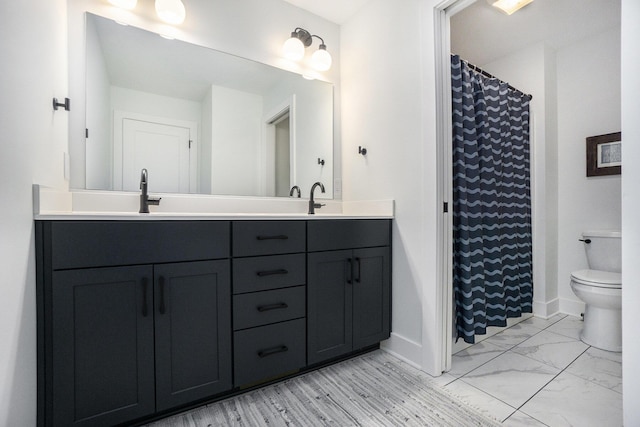 bathroom featuring vanity, curtained shower, and toilet