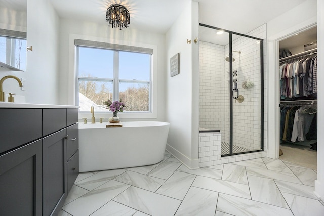 bathroom with vanity and separate shower and tub