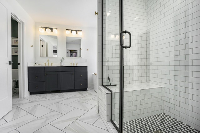 bathroom featuring vanity, toilet, and a shower with shower door