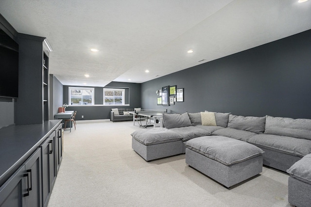 living room with light carpet and a textured ceiling