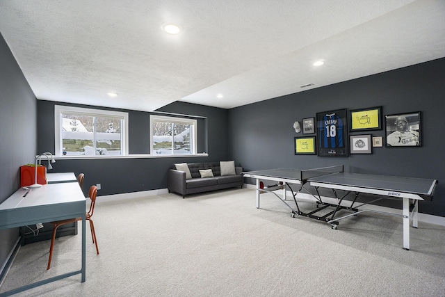 rec room with carpet floors and a textured ceiling