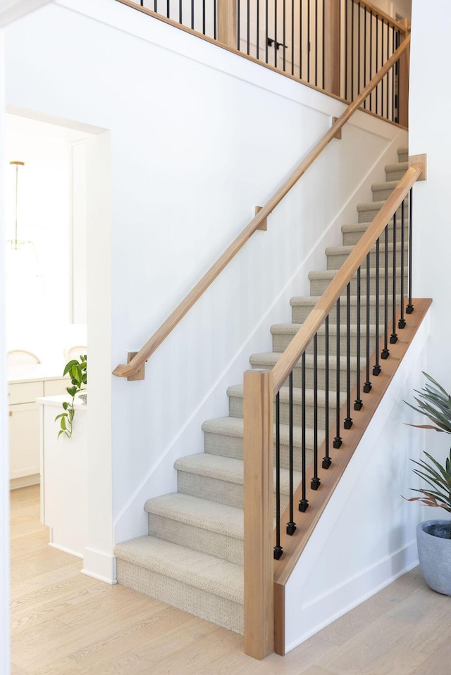 stairs featuring hardwood / wood-style floors