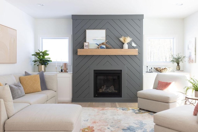 living room featuring light hardwood / wood-style flooring and a fireplace