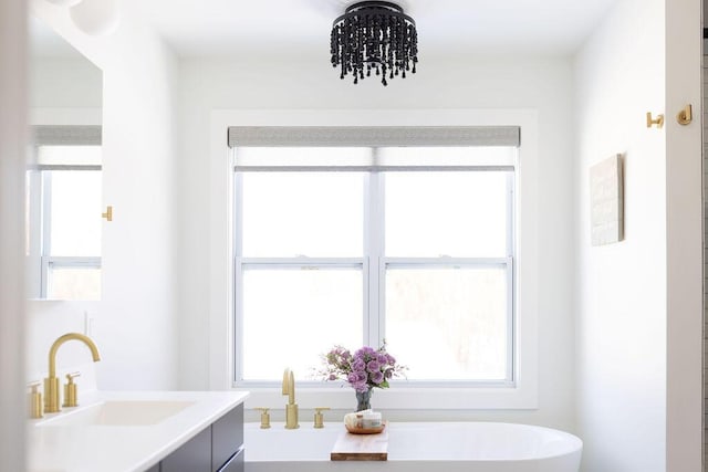 bathroom featuring a tub to relax in and vanity