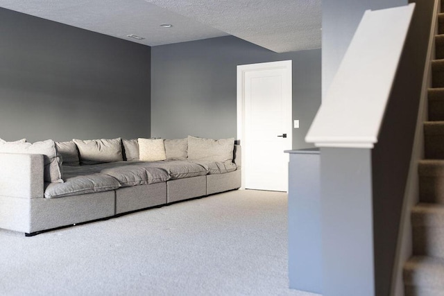 living room featuring a textured ceiling and carpet