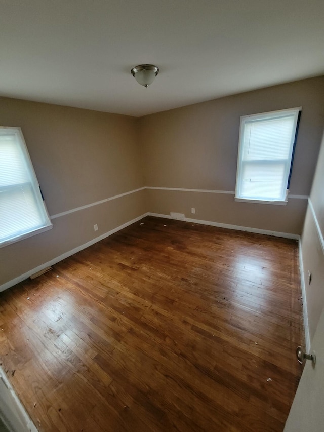 unfurnished room featuring dark wood-type flooring