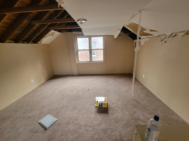 additional living space featuring lofted ceiling and carpet flooring