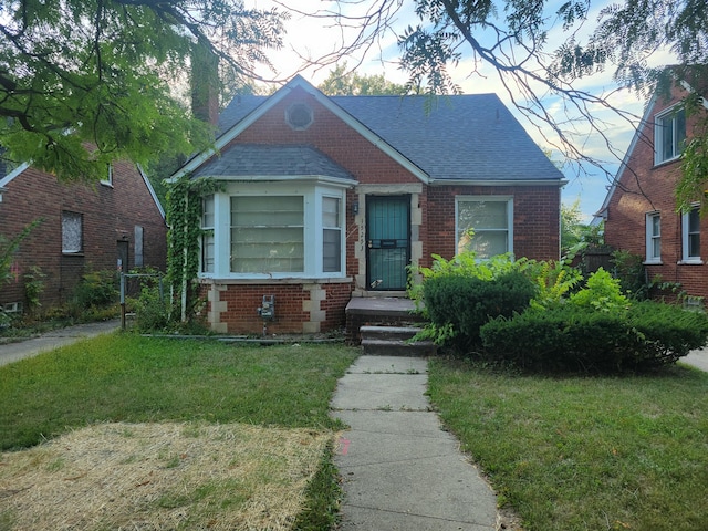 bungalow-style home featuring a front lawn