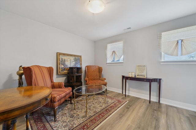 sitting room with hardwood / wood-style flooring