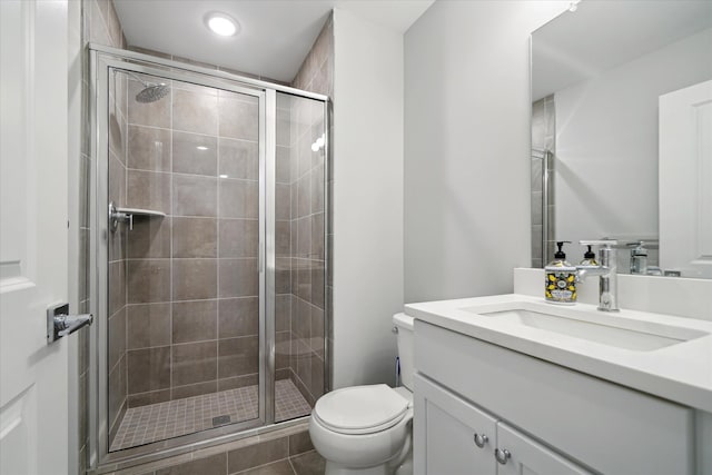 bathroom with vanity, toilet, and an enclosed shower