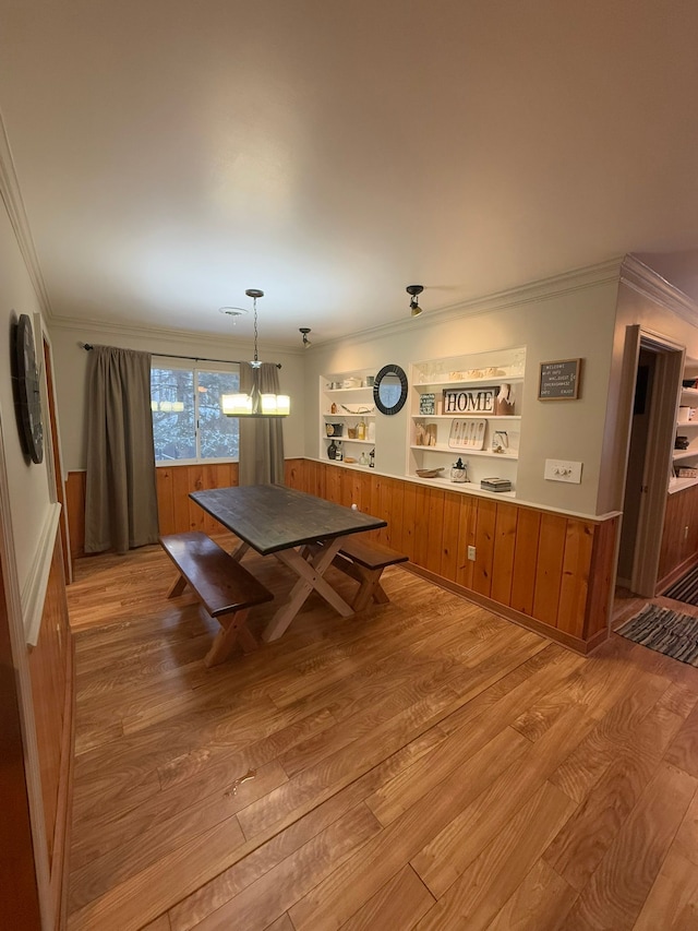 dining room featuring ornamental molding and light hardwood / wood-style flooring