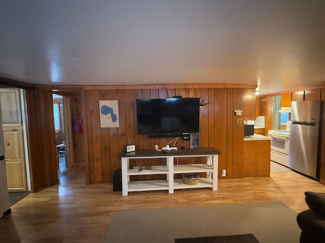 living room featuring wood-type flooring and wooden walls